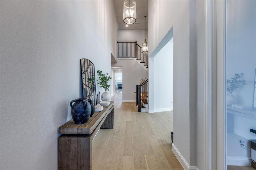 1000 Adair Road Prosper, TX 75078 - Photo 35 of 38 Come home every night to this impressive welcoming! To the right is the home office with 2 french doors, then the bright and sunny dining room and the wrap around stunning staircase.