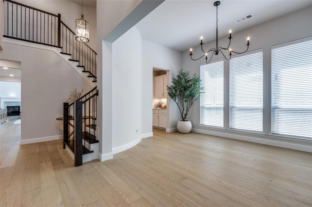 1000 Adair Road Prosper, TX 75078 - Photo 36 of 38 Huge dining area meant to accommodate birthday celebrations and holidays. The doorway in the center of the picture leads you into the oversized butlers pantry area as well as the main kitchen. To the left is the staircase to the second floor and entrance into the main living area and open concept Kitchen....