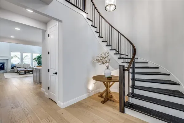 a view of a livingroom with wooden floor and staircase