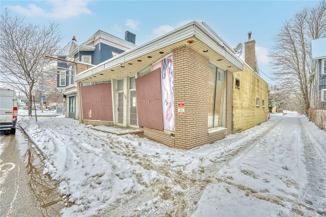 1100 Lyell Avenue Rochester, NY 14606 - Photo 2 of 49 Windows behind wood in good condition. Flat roof o