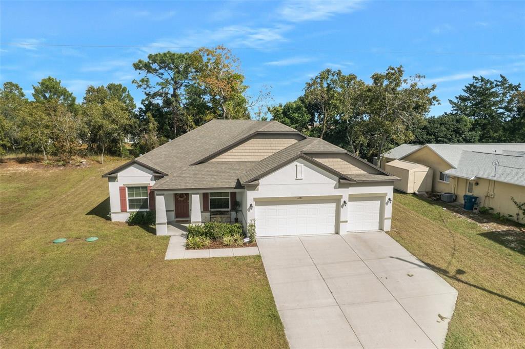 6283 Grapewood Road Spring Hill, FL 34609 - Photo 3 of 41 an aerial view of a house with swimming pool next to a yard