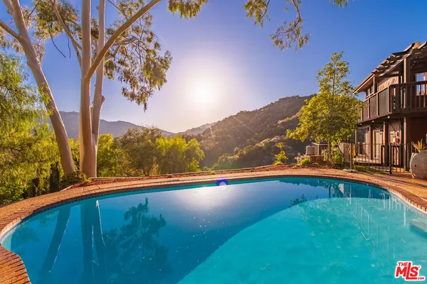 a view of swimming pool with a yard