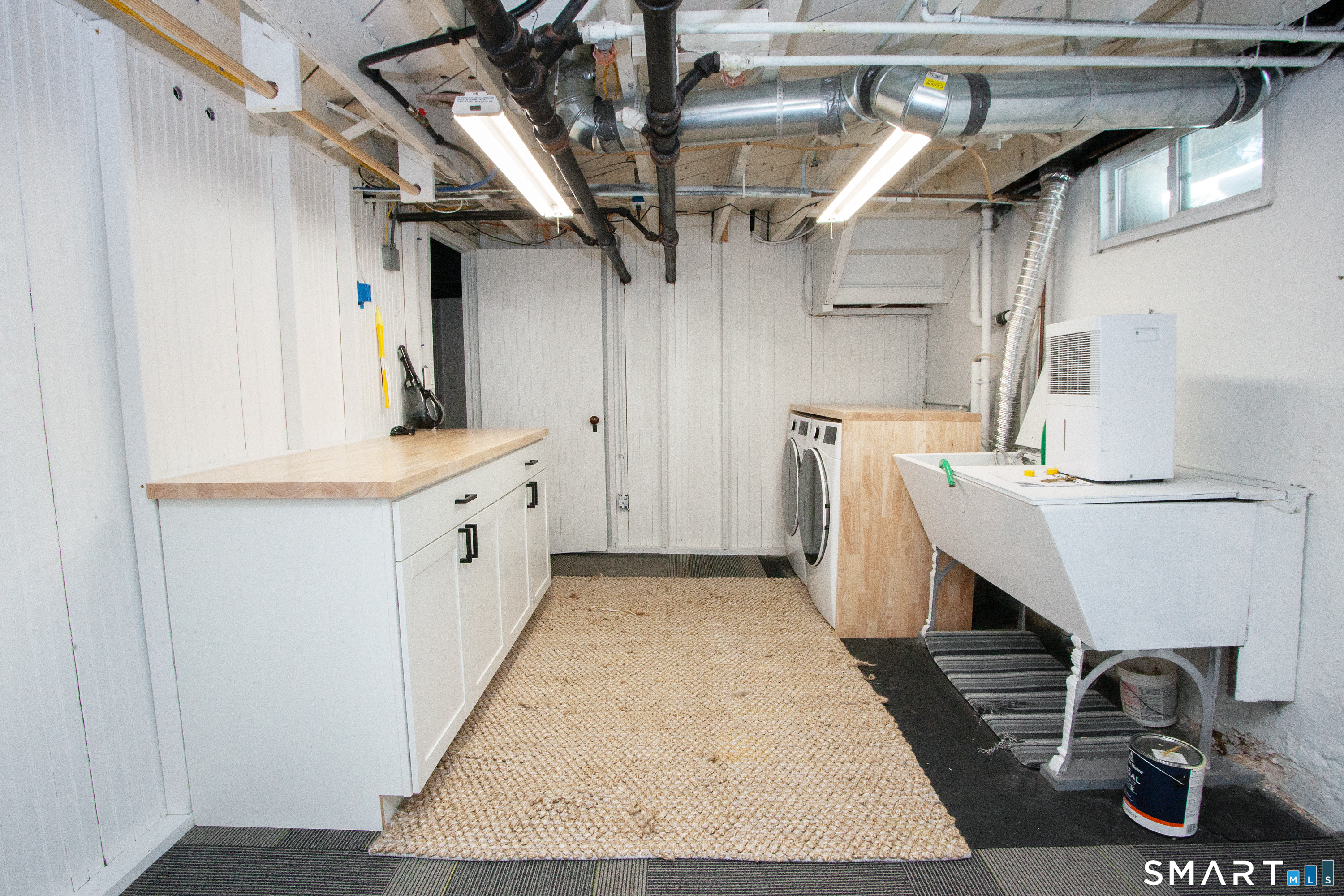 30 Sedgwick Road West Hartford, CT 06107 - Photo 34 of 40 laundry room has sink, storage and folding areas