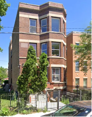 a front view of a residential apartment building with a yard