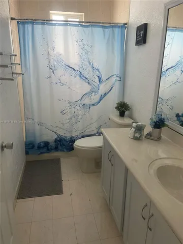 a bedroom with a bed and a mirror