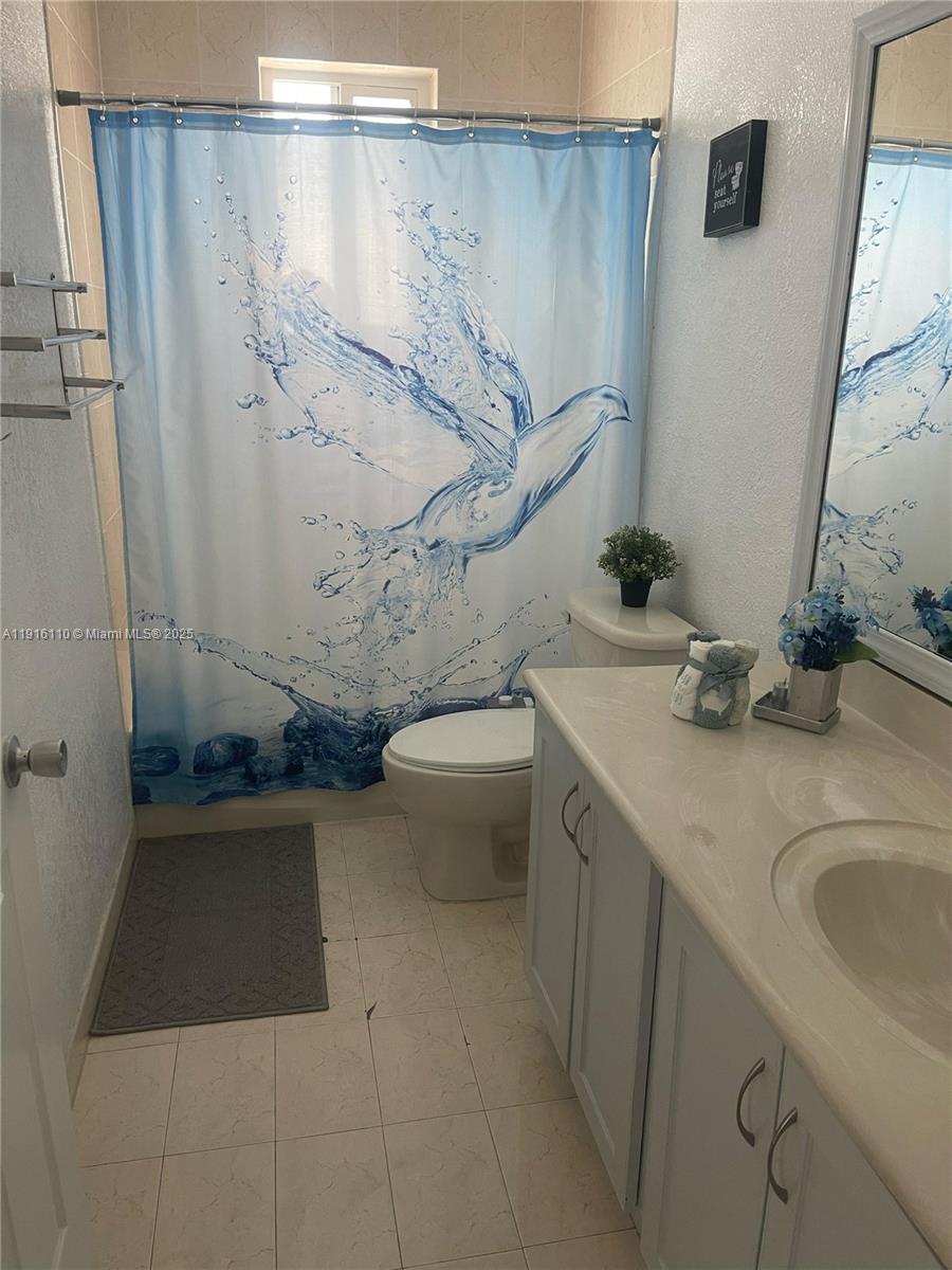 3102 Northeast 3rd Drive Homestead, FL 33033 - Photo 16 of 33 a bathroom with a sink and a mirror