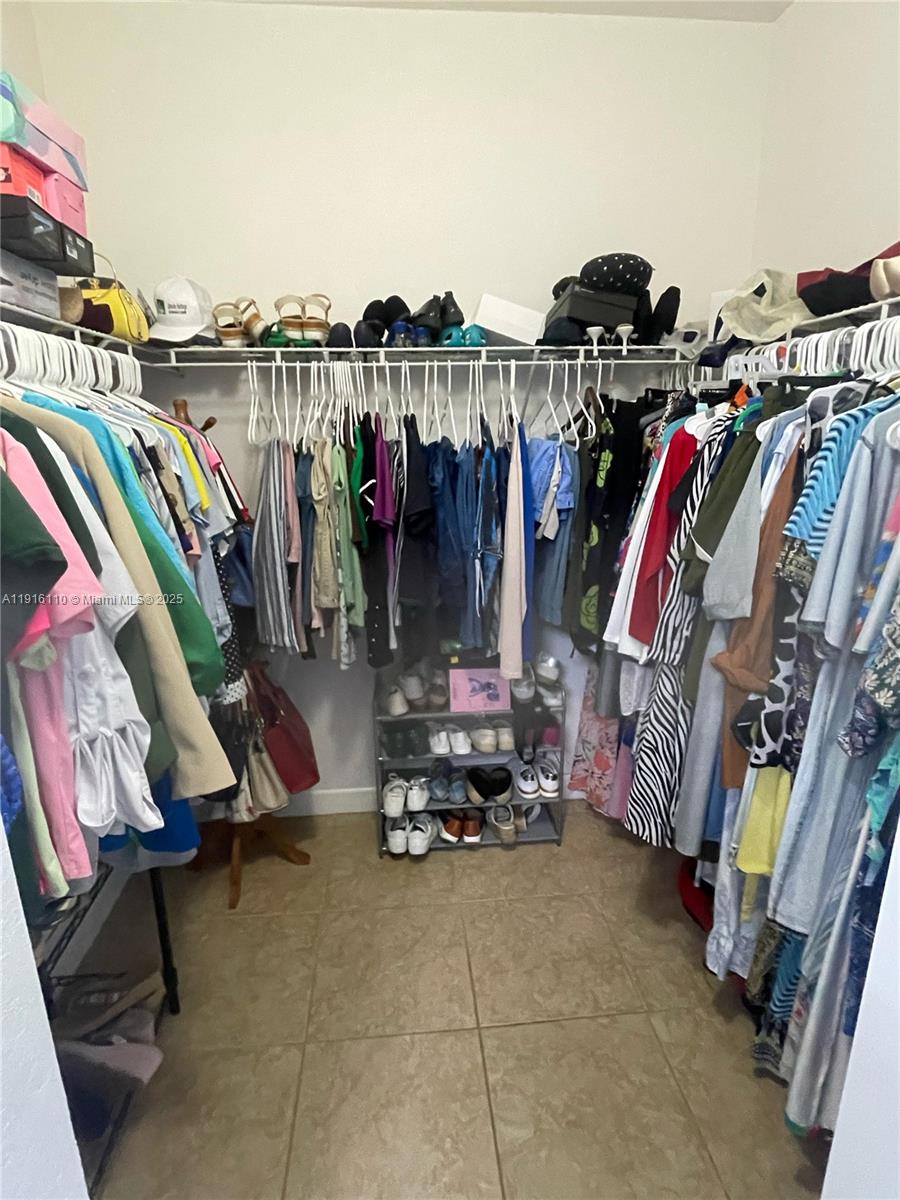 3102 Northeast 3rd Drive Homestead, FL 33033 - Photo 18 of 33 a view of walk in closet with clothes and shoes
