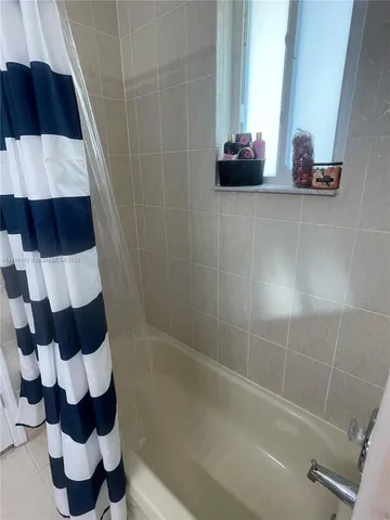 a bathroom with a sink and mirror with toilet