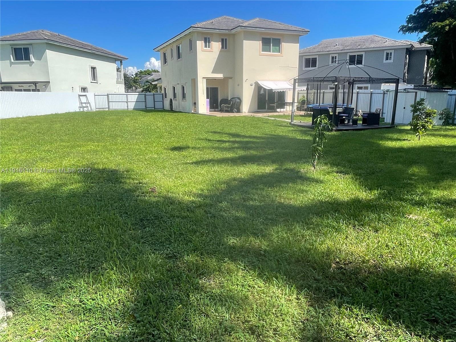 3102 Northeast 3rd Drive Homestead, FL 33033 - Photo 27 of 33 a front view of a house with garden
