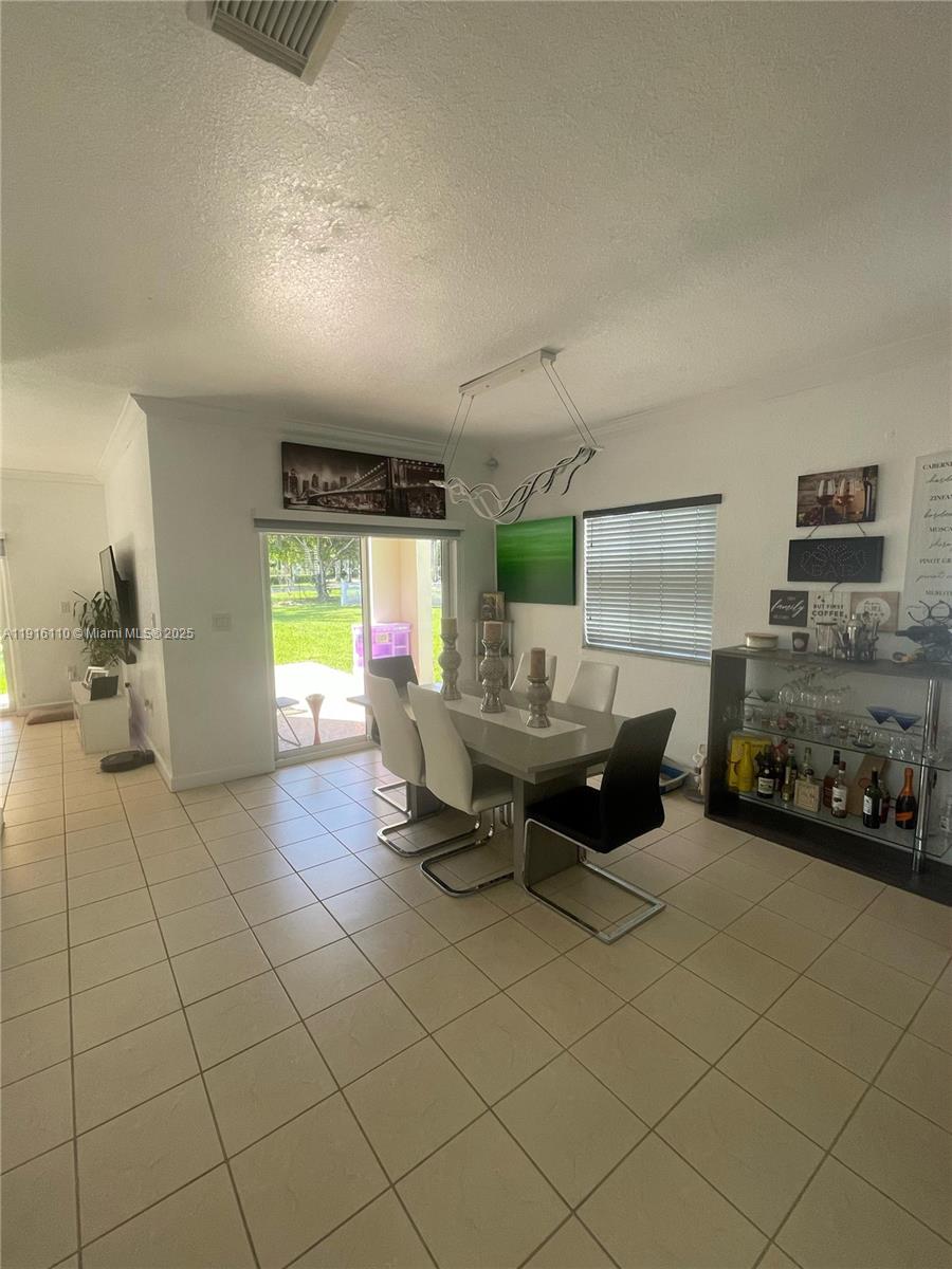 3102 Northeast 3rd Drive Homestead, FL 33033 - Photo 7 of 33 a living room with furniture and a flat screen tv
