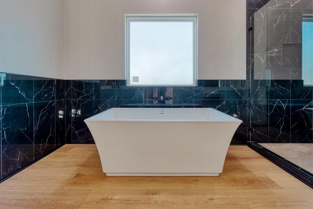 808 North Main Street Tioga, TX 76271 - Photo 15 of 23 a white bath tub sitting in a bathroom