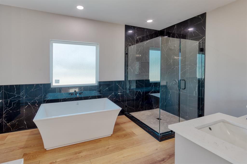 808 North Main Street Tioga, TX 76271 - Photo 16 of 23 a bathroom with a tub and double vanity
