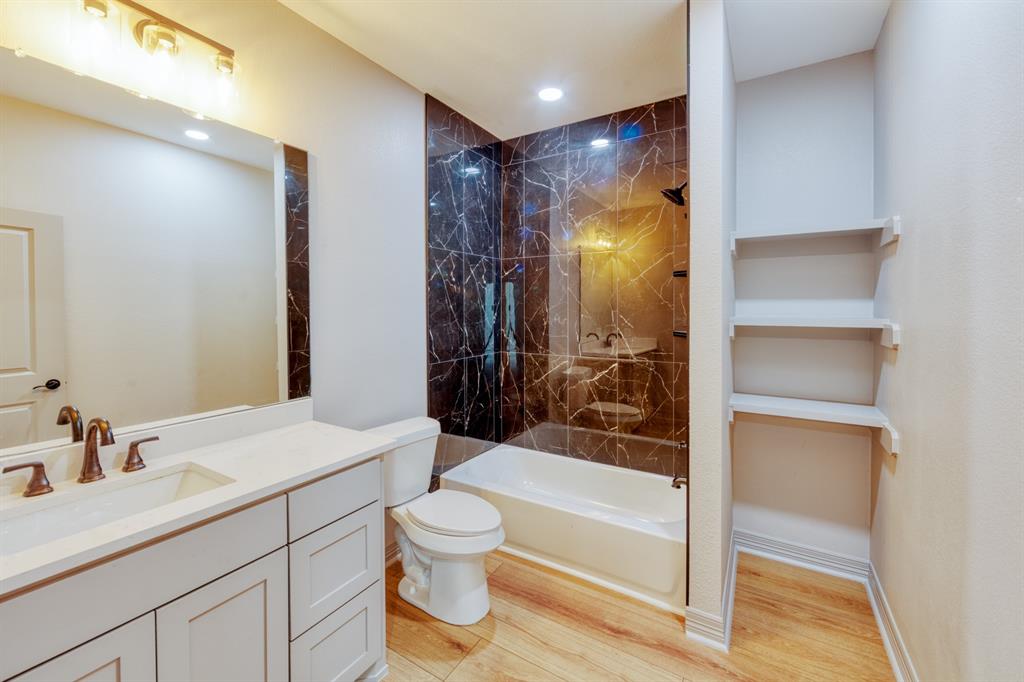 808 North Main Street Tioga, TX 76271 - Photo 18 of 23 a bathroom with a bathtub shower sink vanity and toilet