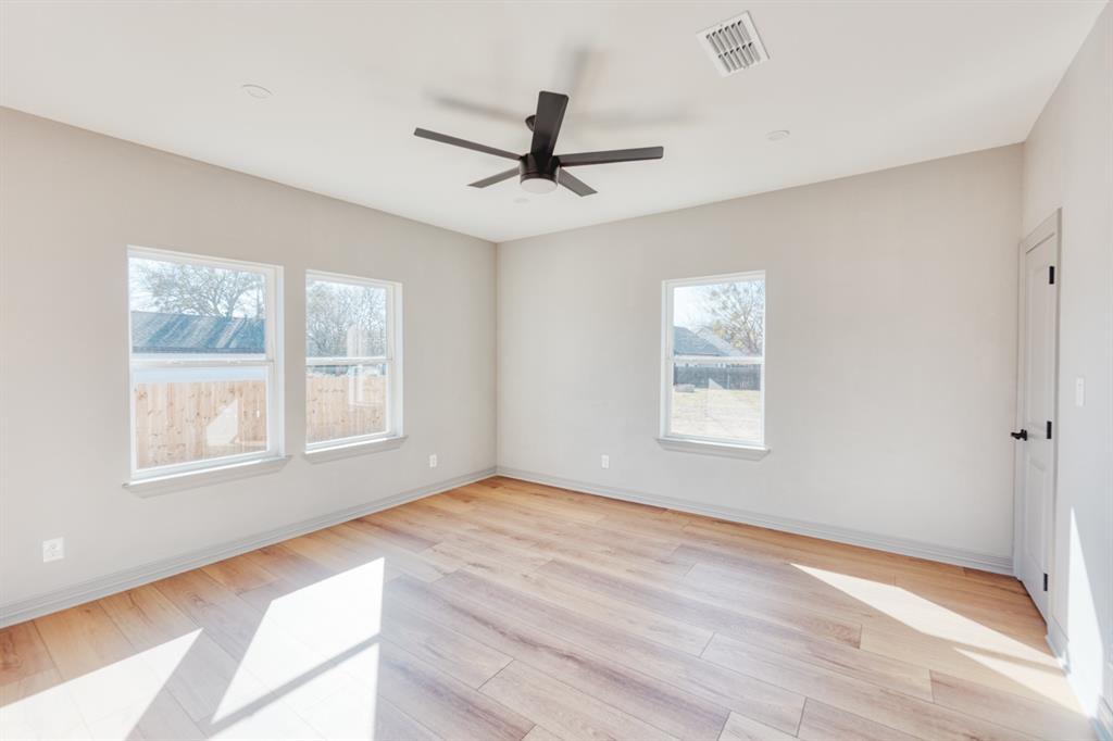 808 North Main Street Tioga, TX 76271 - Photo 19 of 23 a view of an empty room with a window and wooden floor