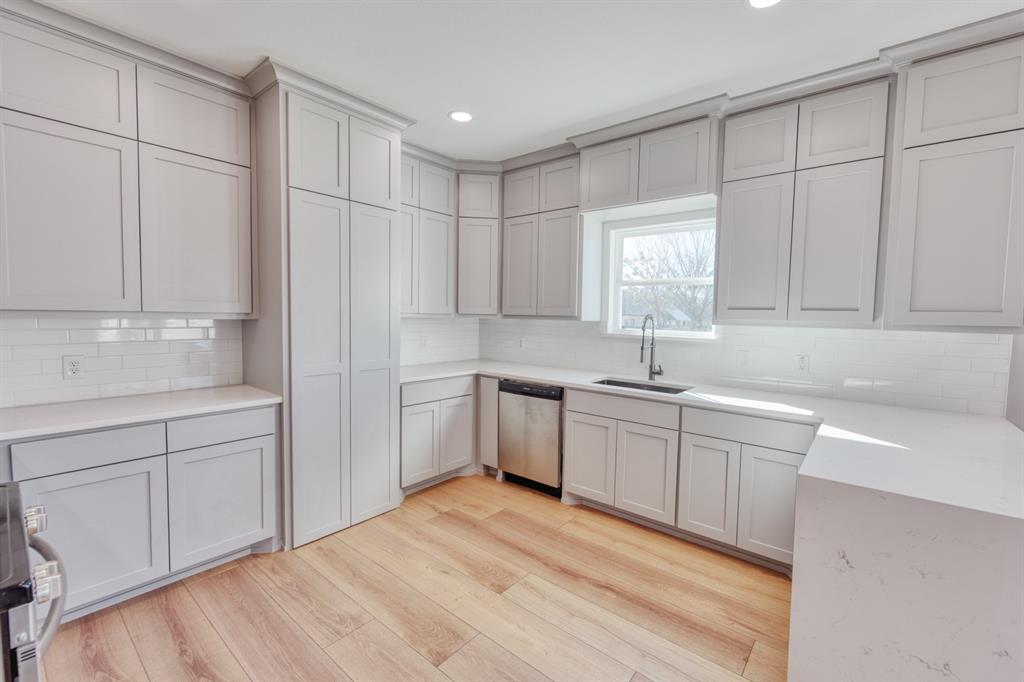 808 North Main Street Tioga, TX 76271 - Photo 5 of 23 a kitchen with white cabinets and white appliances