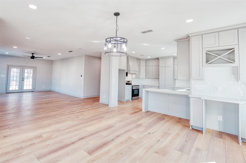 808 North Main Street Tioga, TX 76271 - Photo 8 of 23 a large kitchen with kitchen island a sink stainless steel appliances and cabinets