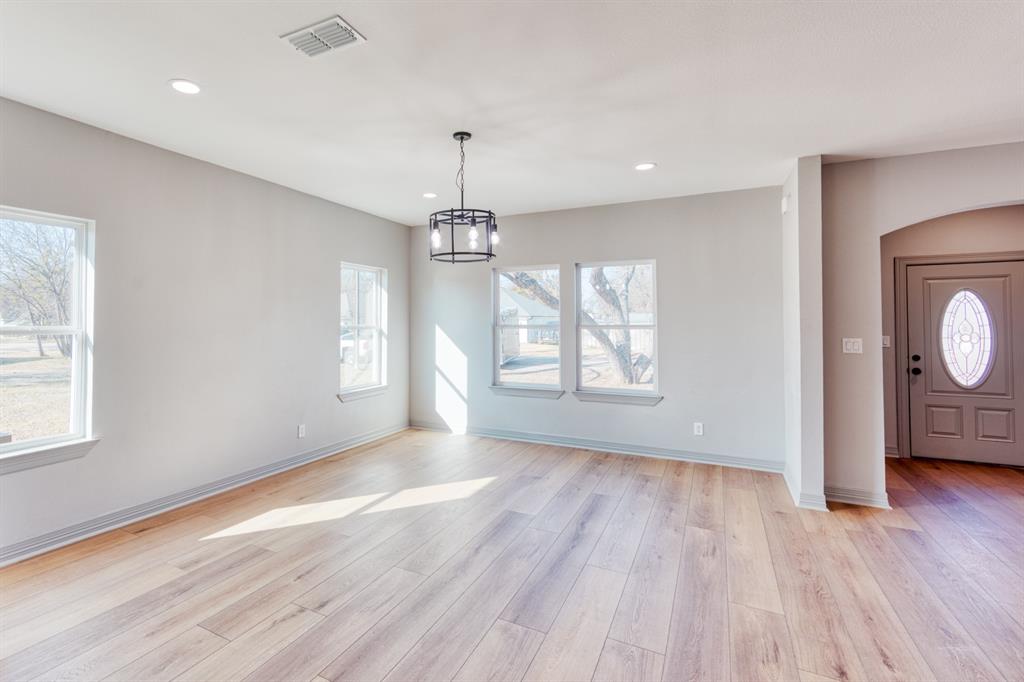 808 North Main Street Tioga, TX 76271 - Photo 9 of 23 a view of livingroom with window wooden floor and chandelier