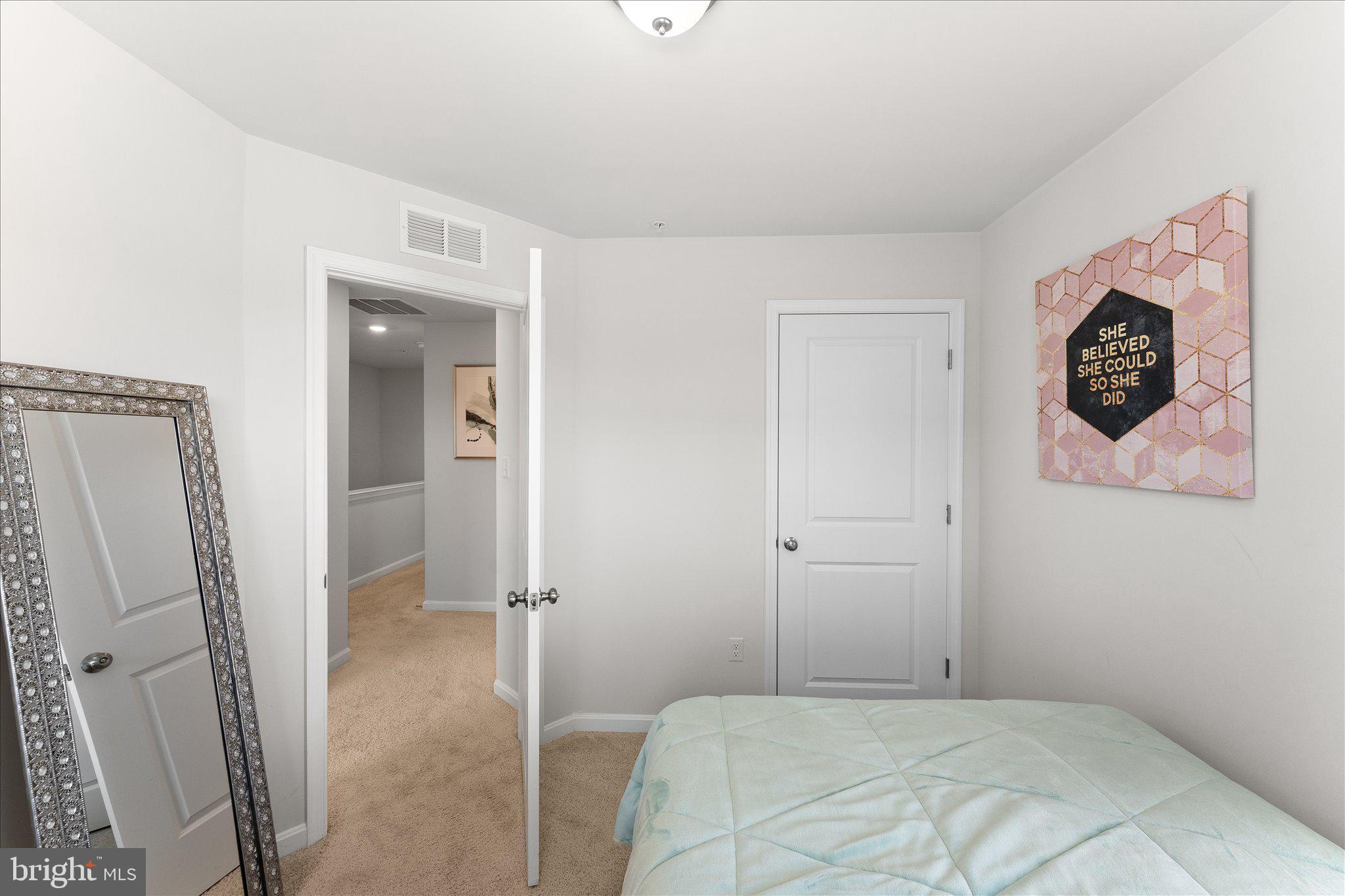 9611 Silver Bluff Way Bowie, MD 20721 - Photo 26 of 33 a bedroom with a bed and a mirror