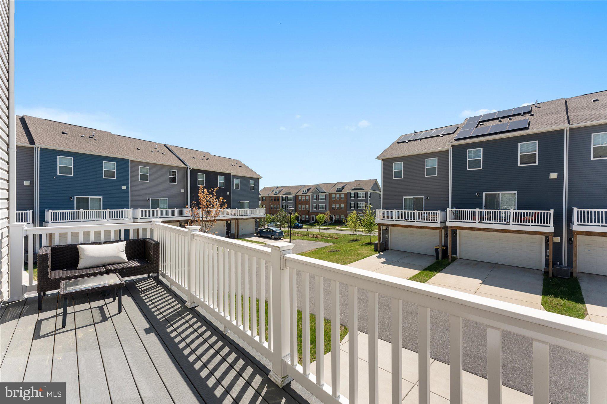 9611 Silver Bluff Way Bowie, MD 20721 - Photo 29 of 33 a view of a balcony with two couches and wooden floor