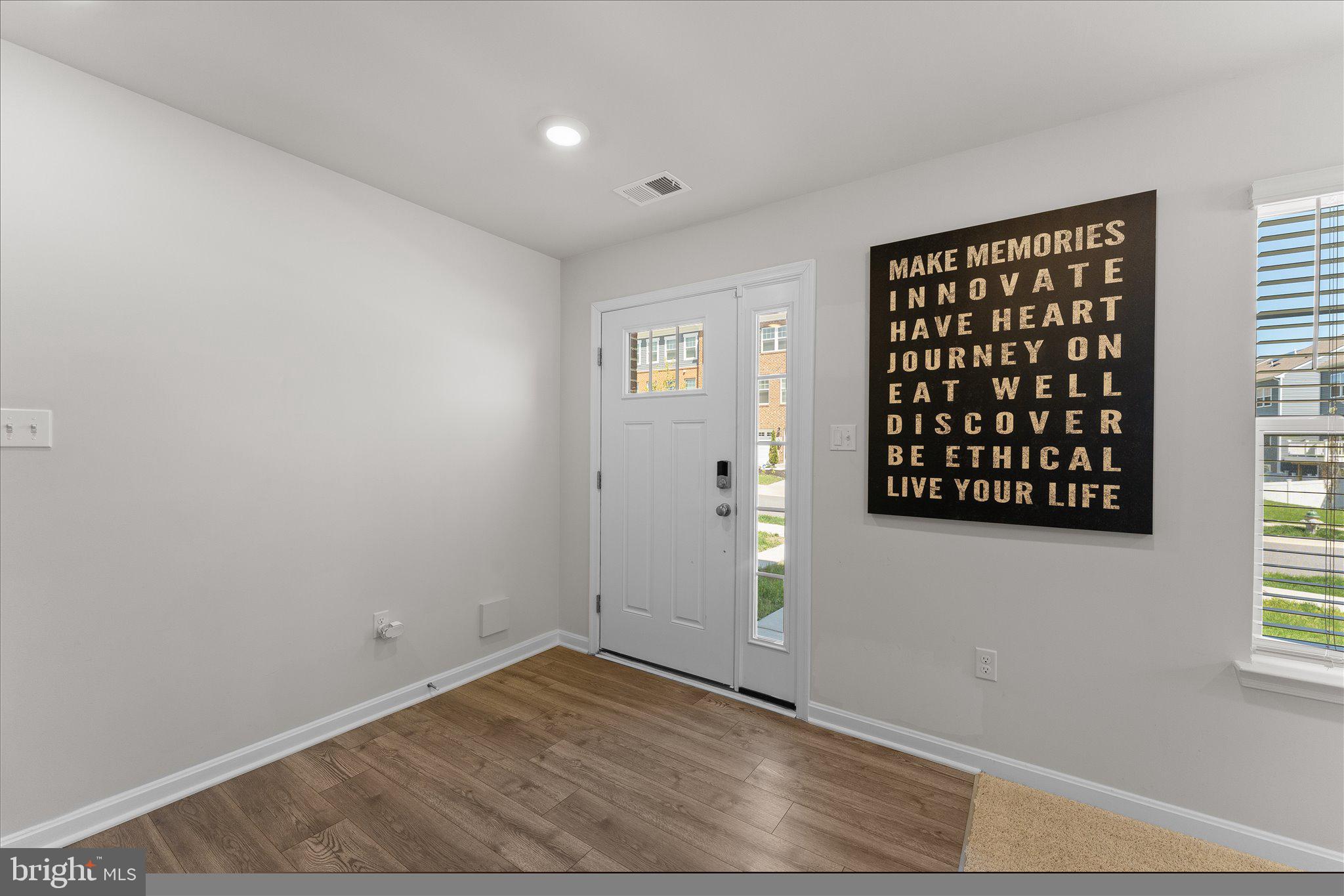 9611 Silver Bluff Way Bowie, MD 20721 - Photo 4 of 33 an empty room with wooden floor and windows