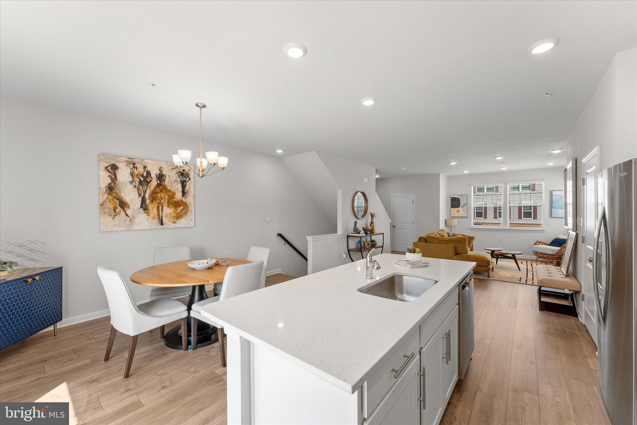 9611 Silver Bluff Way Bowie, MD 20721 - Photo 9 of 33 a living room with stainless steel appliances kitchen island granite countertop furniture and a wooden floor