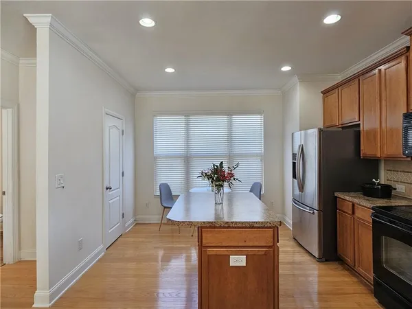 a kitchen with stainless steel appliances a refrigerator sink and microwave