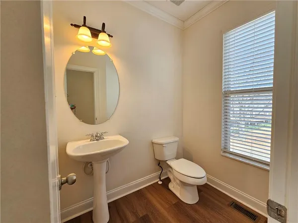 a bathroom with a toilet a sink and a mirror