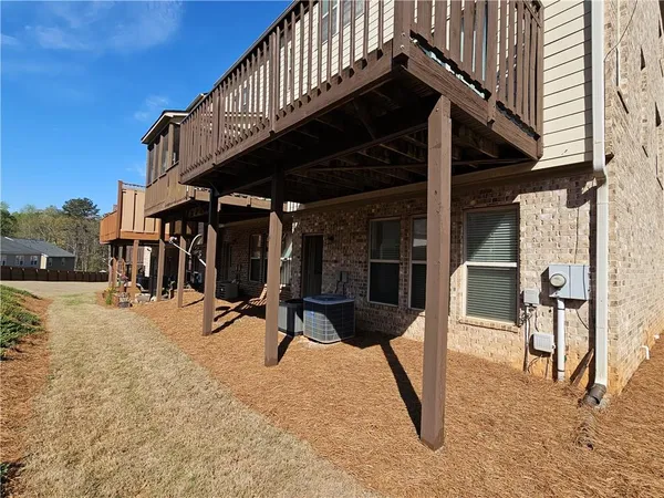 a view of a house with backyard and sitting area