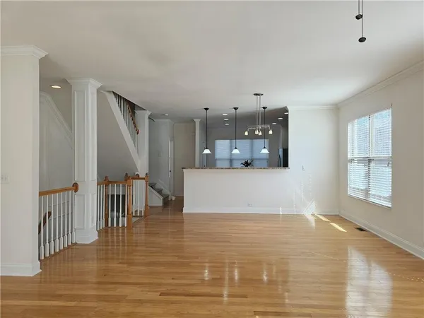 a living room with kitchen island furniture and a wooden floor