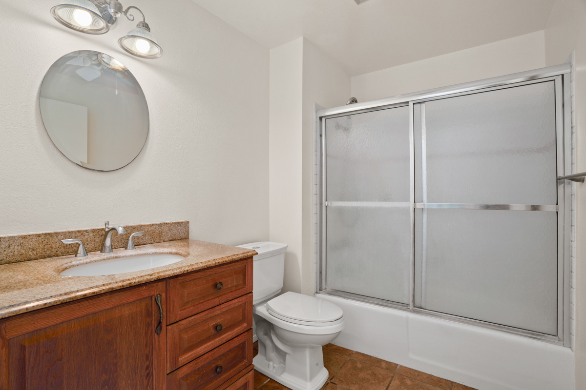 3057 Poipu Road, Unit A1 Koloa, HI 96756 - Photo 12 of 19 a bathroom with a toilet a sink and a mirror