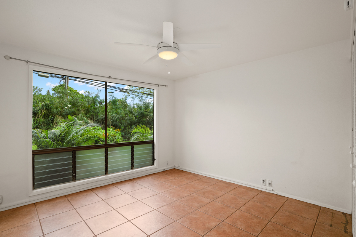 3057 Poipu Road, Unit A1 Koloa, HI 96756 - Photo 14 of 19 an empty room with wooden floor and windows