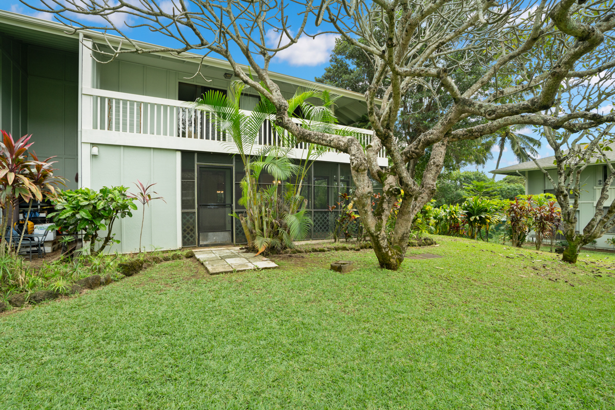 3057 Poipu Road, Unit A1 Koloa, HI 96756 - Photo 18 of 19 a view of a house with a yard and sitting area