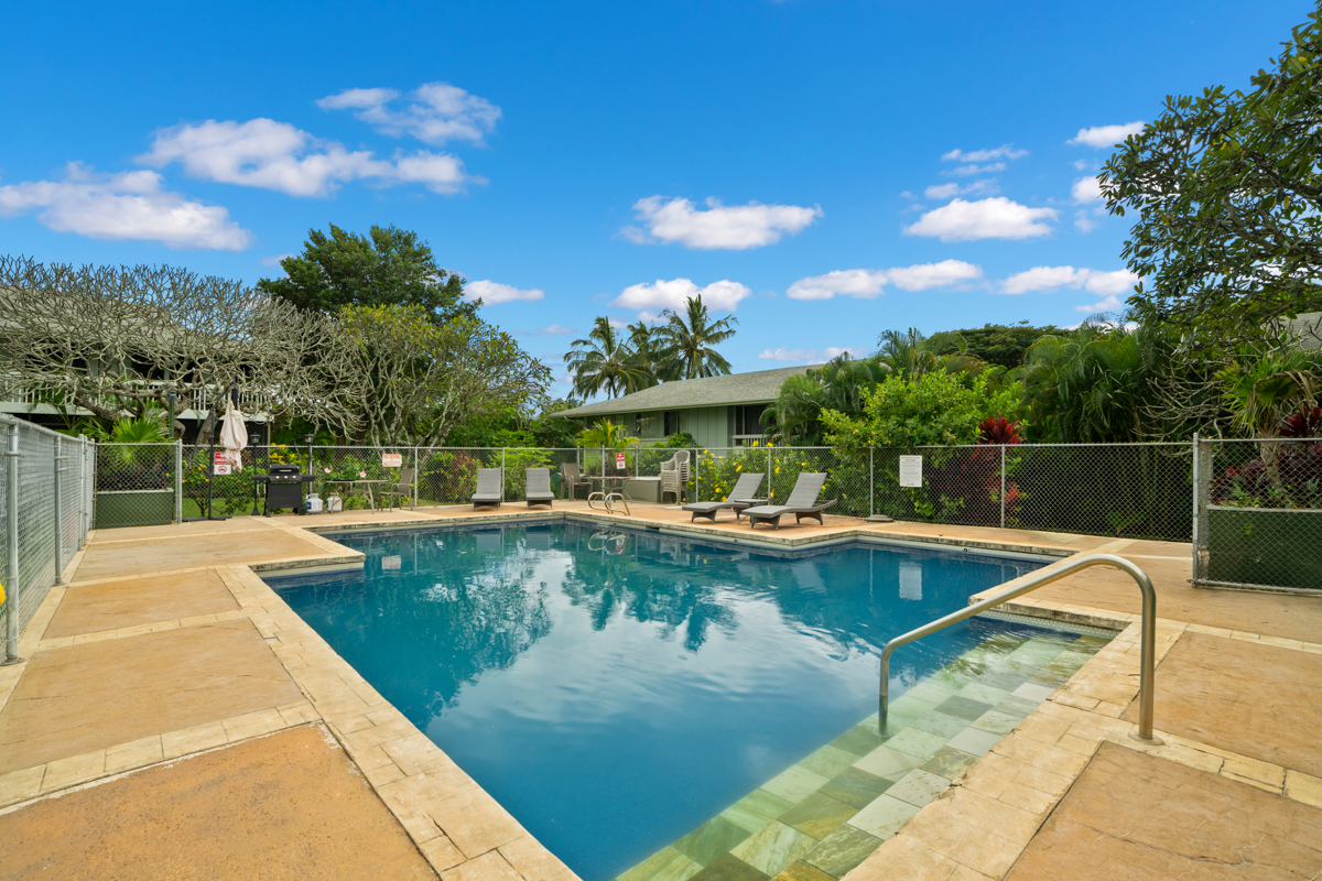 3057 Poipu Road, Unit A1 Koloa, HI 96756 - Photo 19 of 19 a view of a swimming pool with a lounge chair