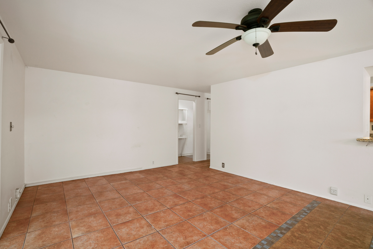 3057 Poipu Road, Unit A1 Koloa, HI 96756 - Photo 8 of 19 an empty room with a ceiling fan and carpet