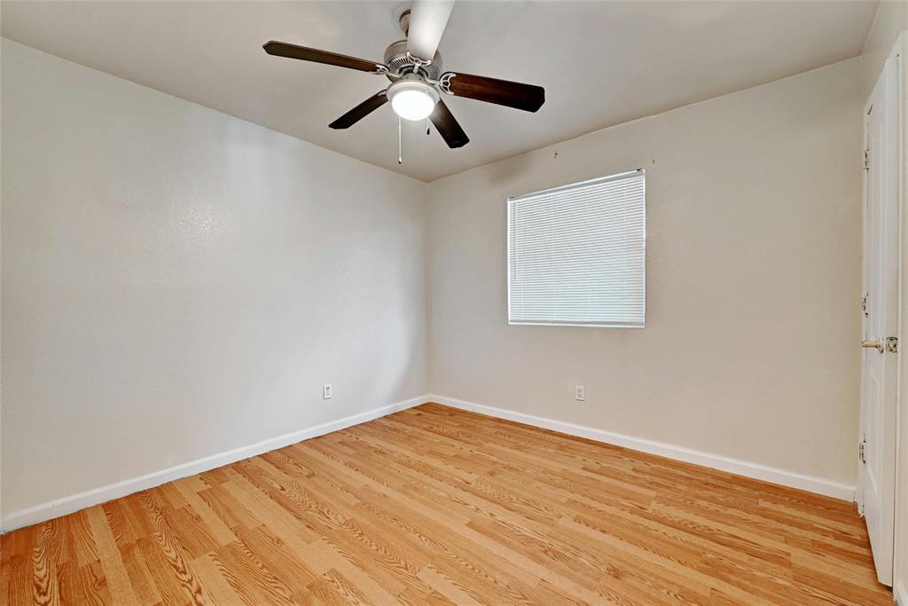 3312 Plantation Road Austin, TX 78745 - Photo 10 of 10 an empty room with wooden floor and ceiling fan
