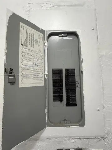a view of a kitchen with stainless steel appliances granite countertop a sink and wooden cabinets