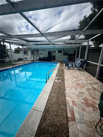 a living room with a gaming machine and table