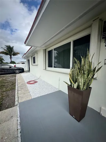 a view of a house with a potted plant in front of it