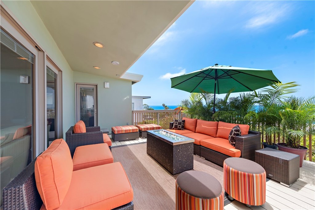 a outdoor space with patio couch chairs and an umbrella