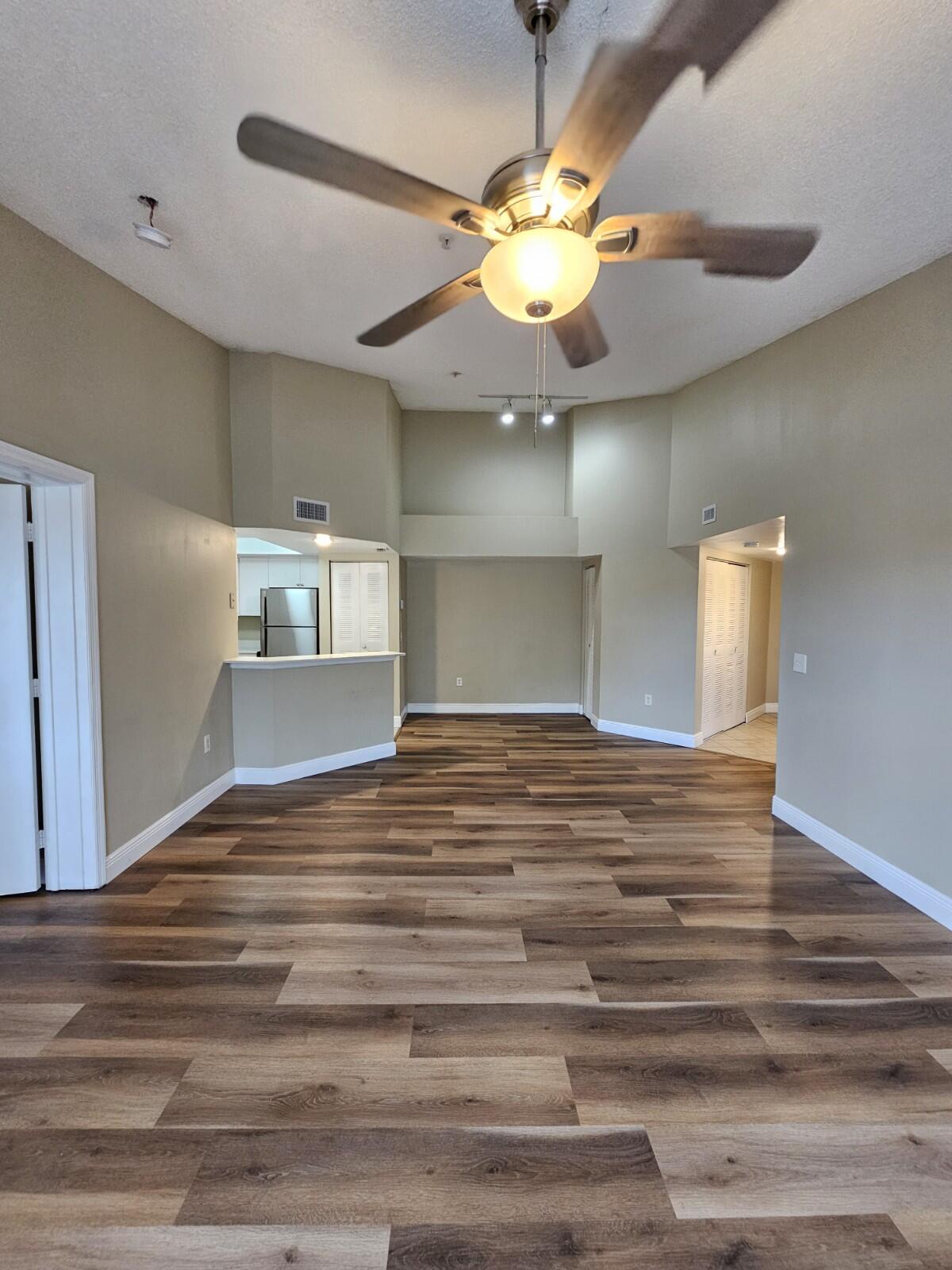 4191 Haverhill Road, Unit 408 West Palm Beach, FL 33417 - Photo 1 of 22 a view of a room with wooden floor and chandelier