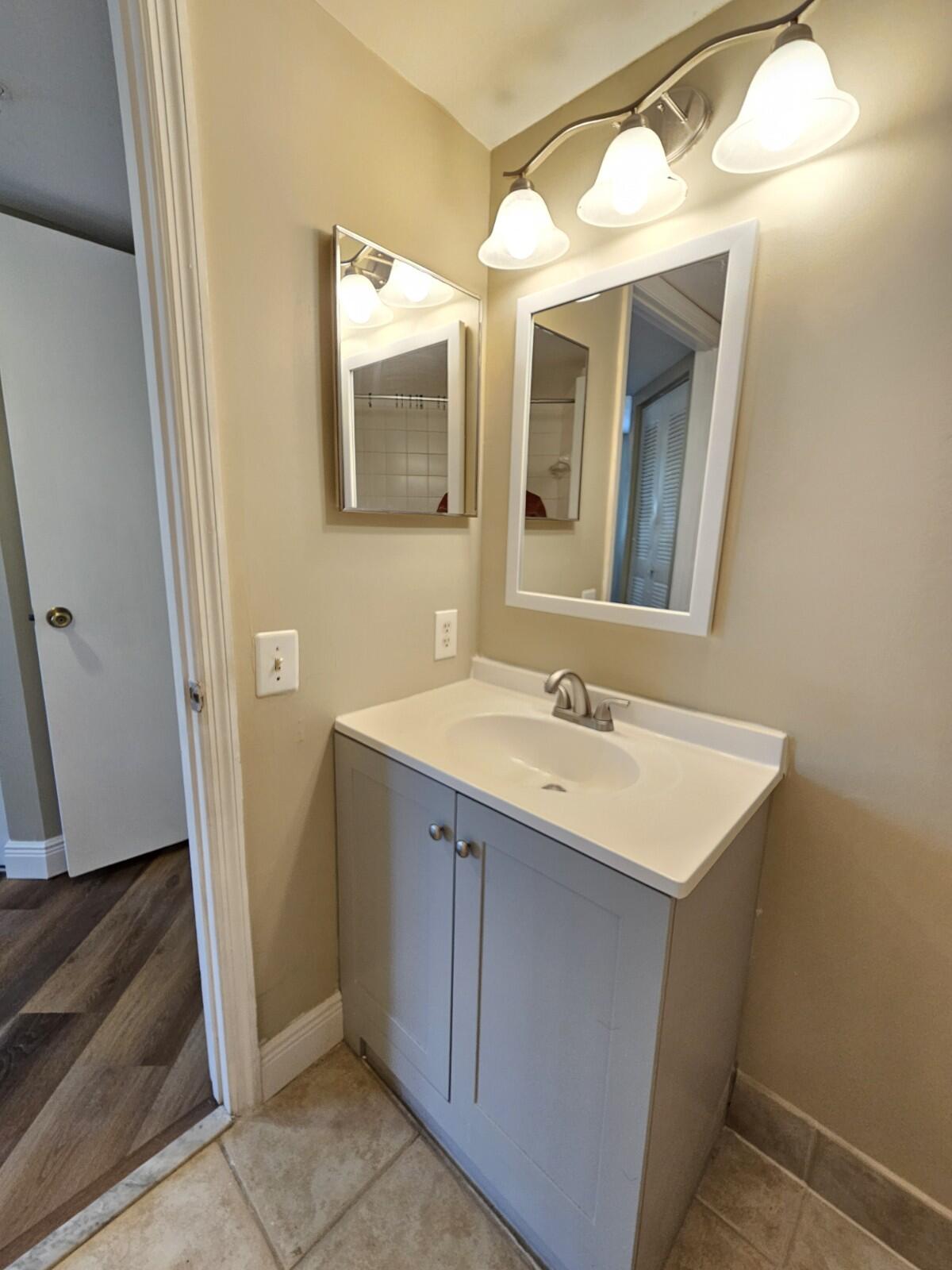 4191 Haverhill Road, Unit 408 West Palm Beach, FL 33417 - Photo 11 of 22 a bathroom with a sink and a mirror