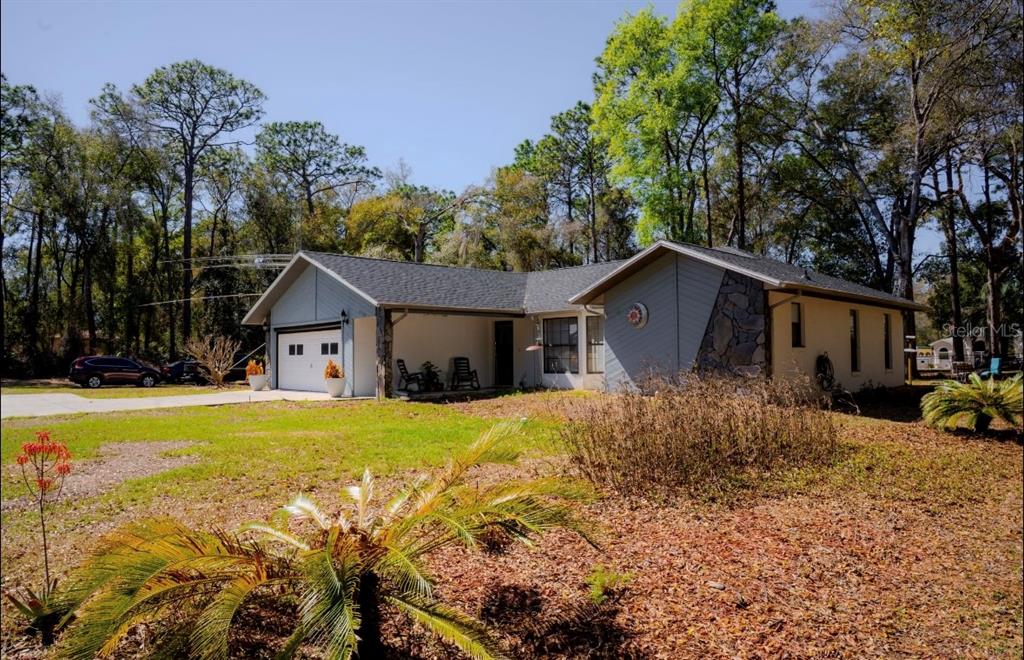 4150 South Apopka Avenue Inverness, FL 34452 - Photo 11 of 84 a front view of house with yard and trees in the background