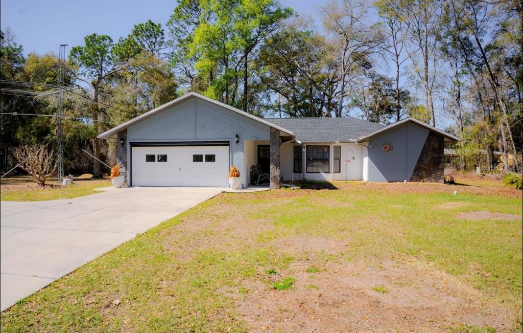 4150 South Apopka Avenue Inverness, FL 34452 - Photo 2 of 84 a front view of a house with a yard and garage