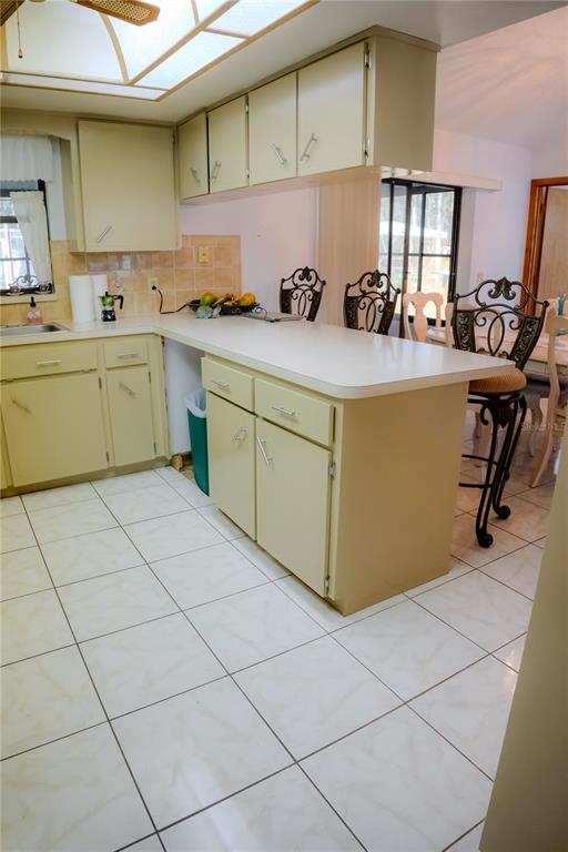 4150 South Apopka Avenue Inverness, FL 34452 - Photo 27 of 84 a kitchen with a sink a stove cabinets and a dining table