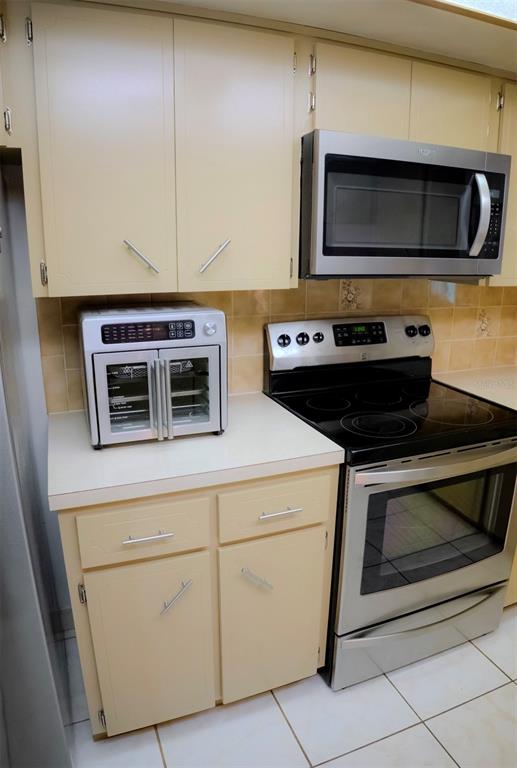 4150 South Apopka Avenue Inverness, FL 34452 - Photo 30 of 84 a kitchen with microwave cabinets and stainless steel appliances