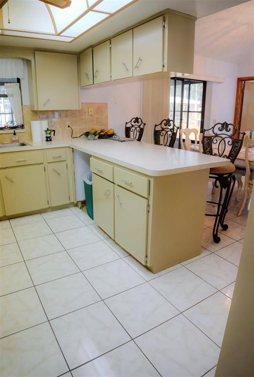4150 South Apopka Avenue Inverness, FL 34452 - Photo 32 of 84 a kitchen with a sink a stove cabinets and a counter top space