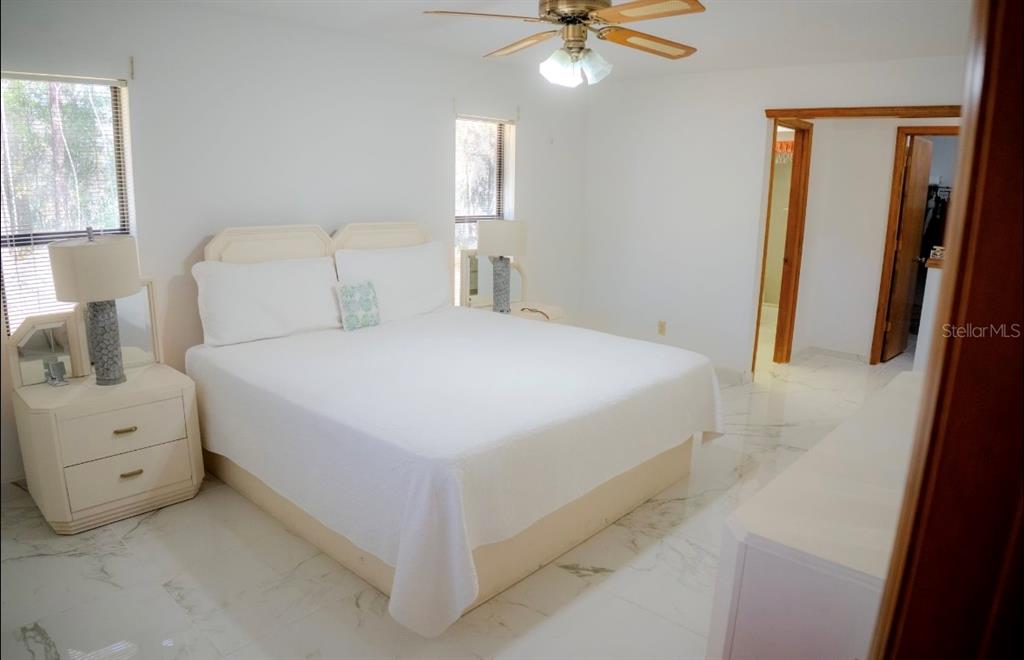 4150 South Apopka Avenue Inverness, FL 34452 - Photo 33 of 84 a bedroom with a bed and a chandelier