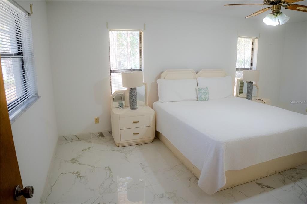 4150 South Apopka Avenue Inverness, FL 34452 - Photo 35 of 84 a bedroom with a bed and a chandelier