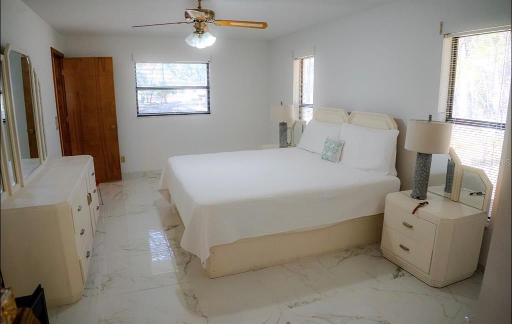 4150 South Apopka Avenue Inverness, FL 34452 - Photo 39 of 84 a bedroom with a bed and a chandelier
