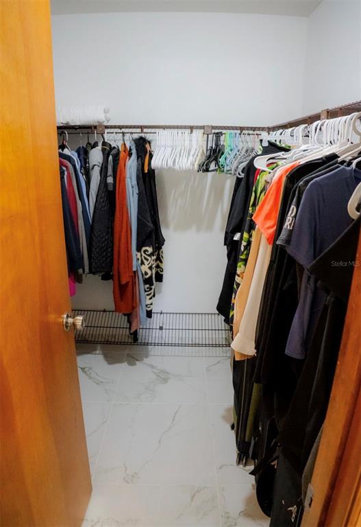4150 South Apopka Avenue Inverness, FL 34452 - Photo 40 of 84 a view of walk in closet with clothes and shoes